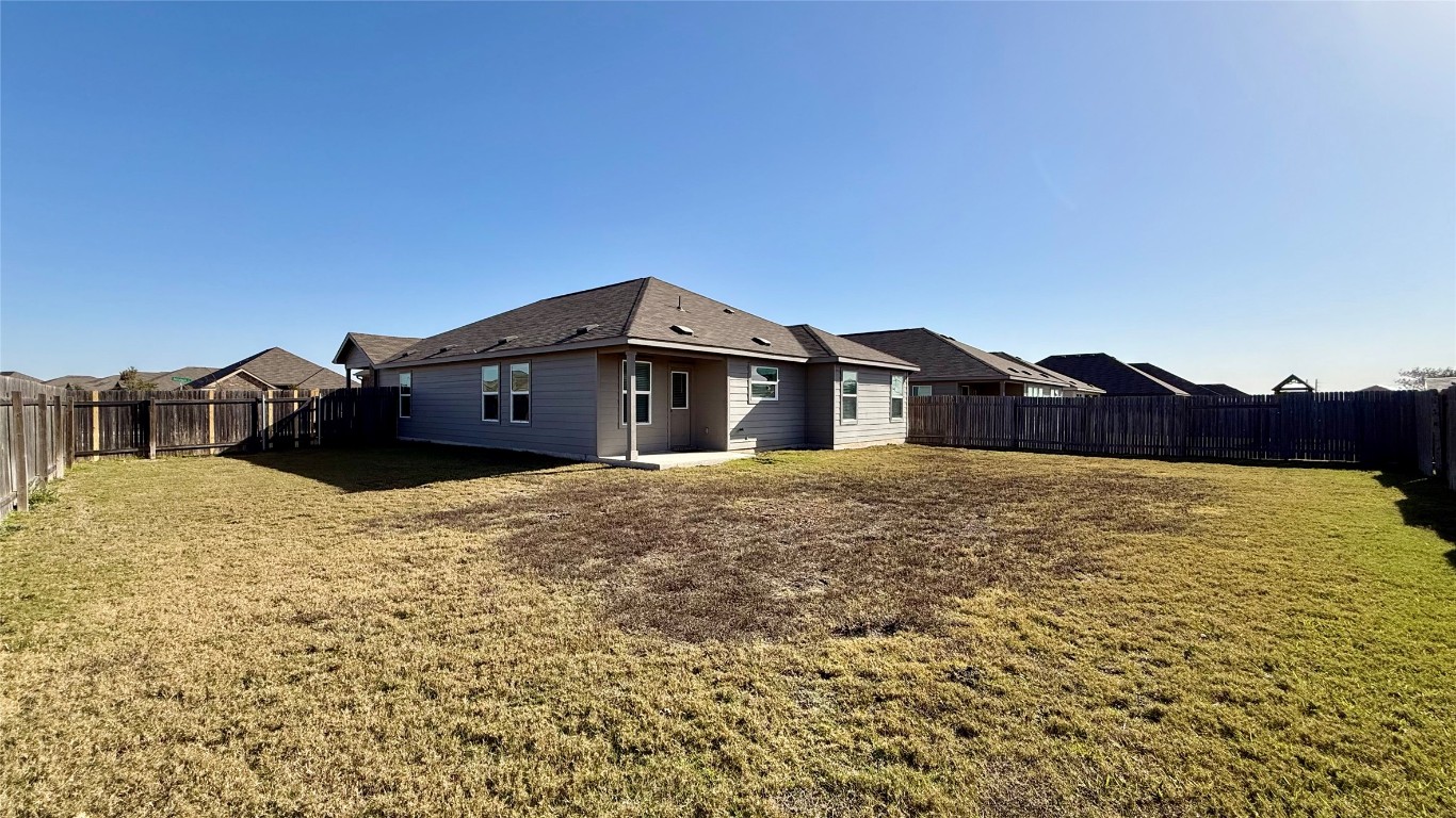 1000 Berryhack Court Hutto, TX 78634 - Photo 20 of 22 Back of house featuring a patio, a fenced backyard, and a residential view