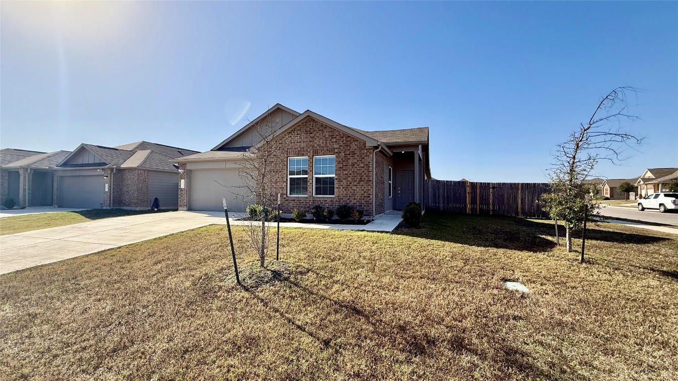 1000 Berryhack Court Hutto, TX 78634 - Photo 3 of 22 Single story home with brick siding, concrete driveway, and a garage