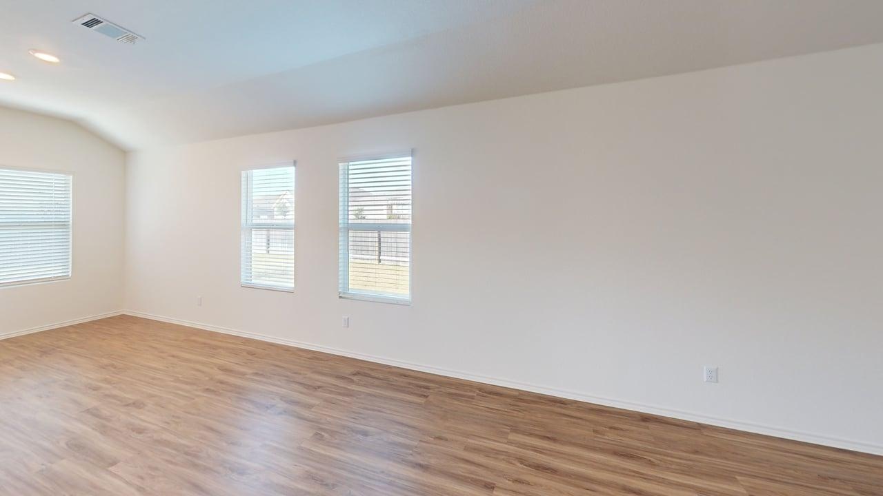 1000 Berryhack Court Hutto, TX 78634 - Photo 7 of 22 Empty room with vaulted ceiling and light wood finished floors