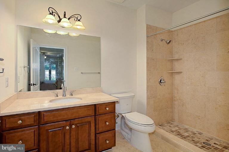 6010 Chesterbrook Road McLean, VA 22101 - Photo 29 of 30 a bathroom with a sink a toilet and shower