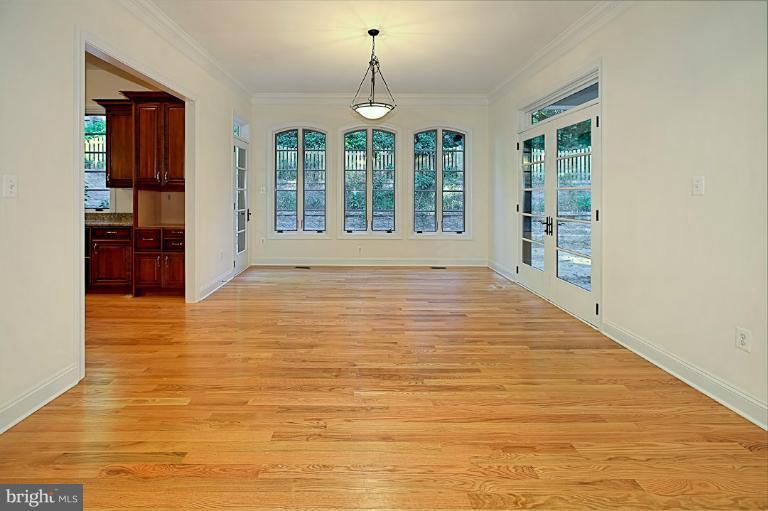 6010 Chesterbrook Road McLean, VA 22101 - Photo 10 of 30 a big room with wooden floor windows and kitchen view