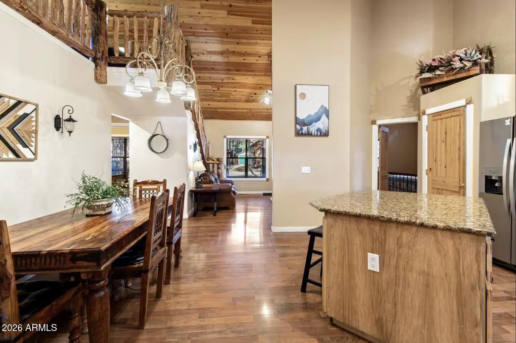 2540 Timber Ridge Lane Pinetop, AZ 85935 - Photo 12 of 37 a dining room with wooden floor and chandelier