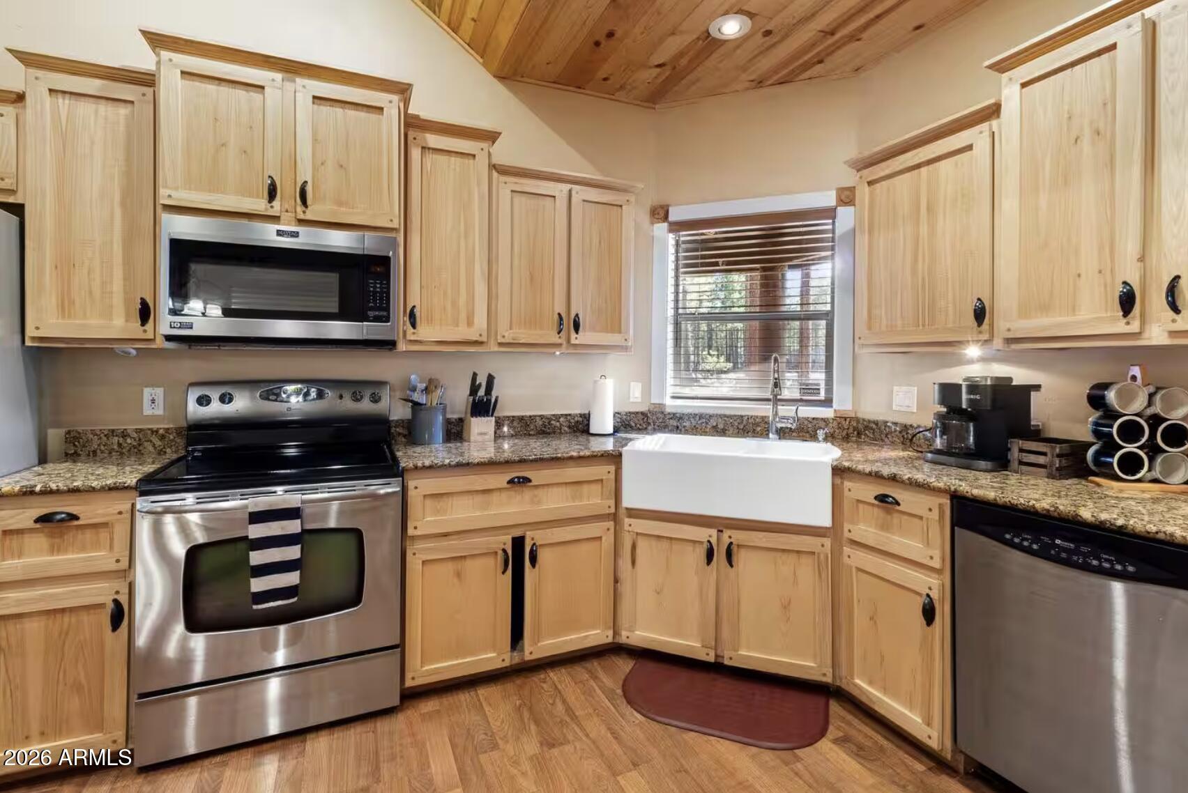 2540 Timber Ridge Lane Pinetop, AZ 85935 - Photo 13 of 37 a kitchen with cabinets stainless steel appliances a sink and a window