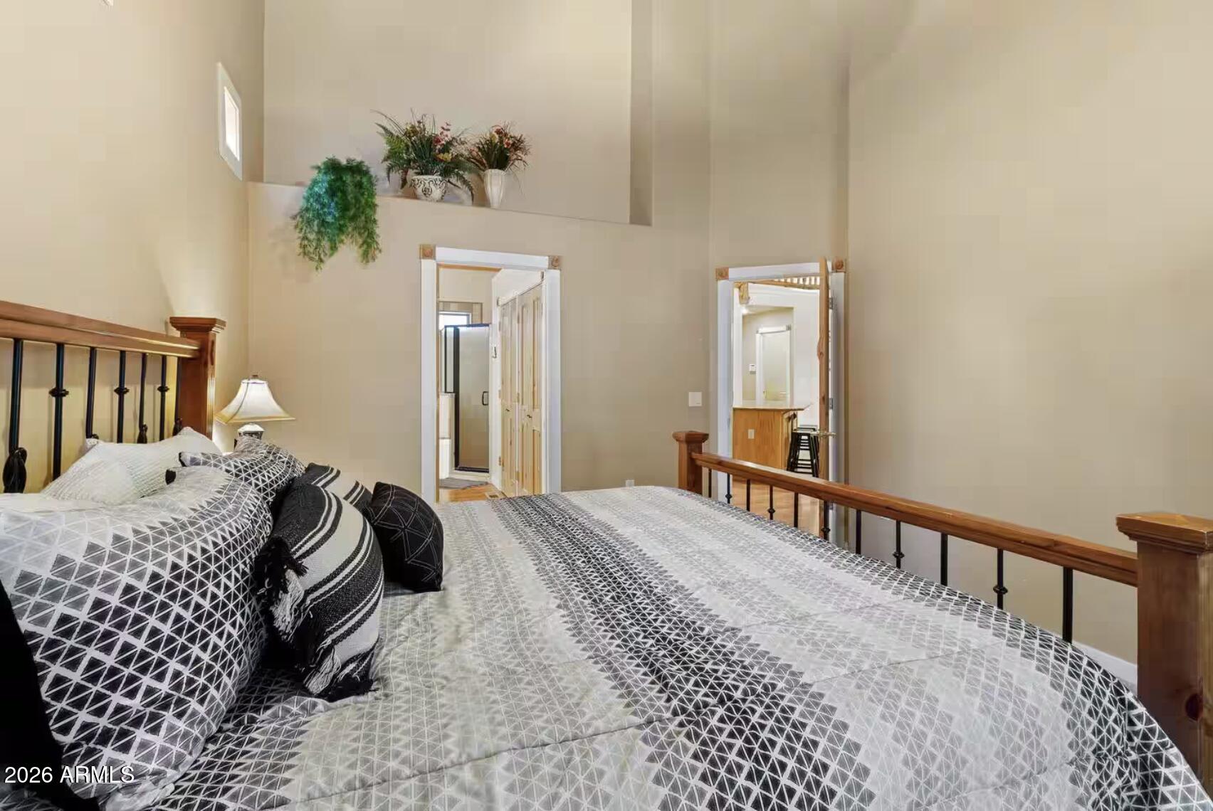 2540 Timber Ridge Lane Pinetop, AZ 85935 - Photo 18 of 37 a bedroom with a bed a mirror and a potted plant