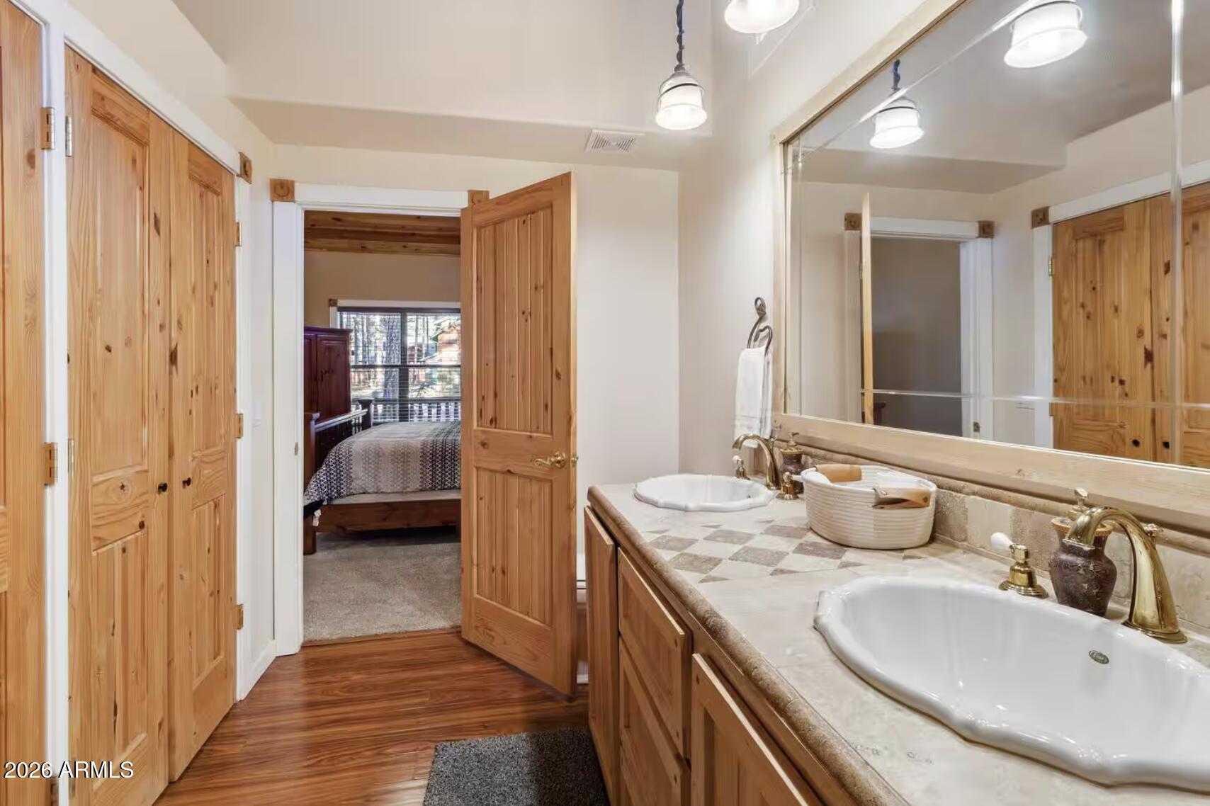 2540 Timber Ridge Lane Pinetop, AZ 85935 - Photo 20 of 37 a en suite bathroom with a double vanity sink and a mirror