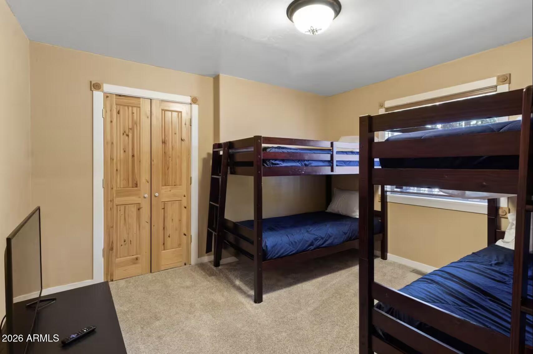 2540 Timber Ridge Lane Pinetop, AZ 85935 - Photo 25 of 37 a bedroom with a bunk bed and a dresser