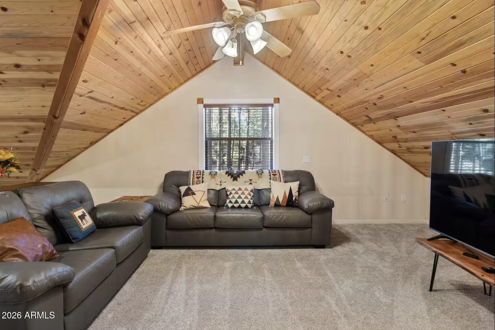 2540 Timber Ridge Lane Pinetop, AZ 85935 - Photo 28 of 37 a living room with furniture a ceiling fan and a rug