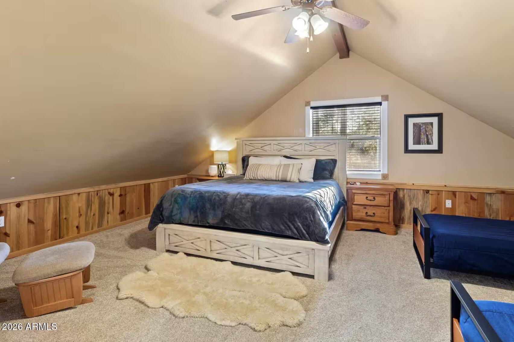 2540 Timber Ridge Lane Pinetop, AZ 85935 - Photo 32 of 37 a bedroom with a large bed and a couch