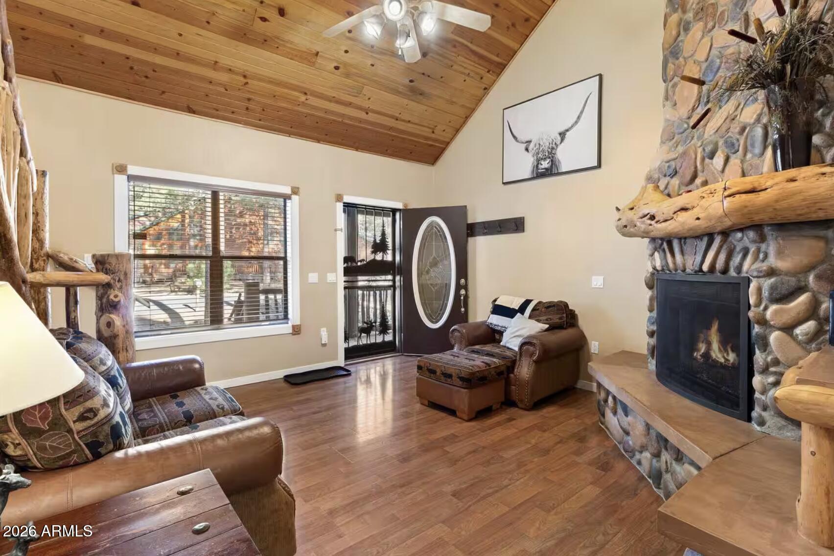 2540 Timber Ridge Lane Pinetop, AZ 85935 - Photo 5 of 37 a living room with furniture a fireplace and a large window