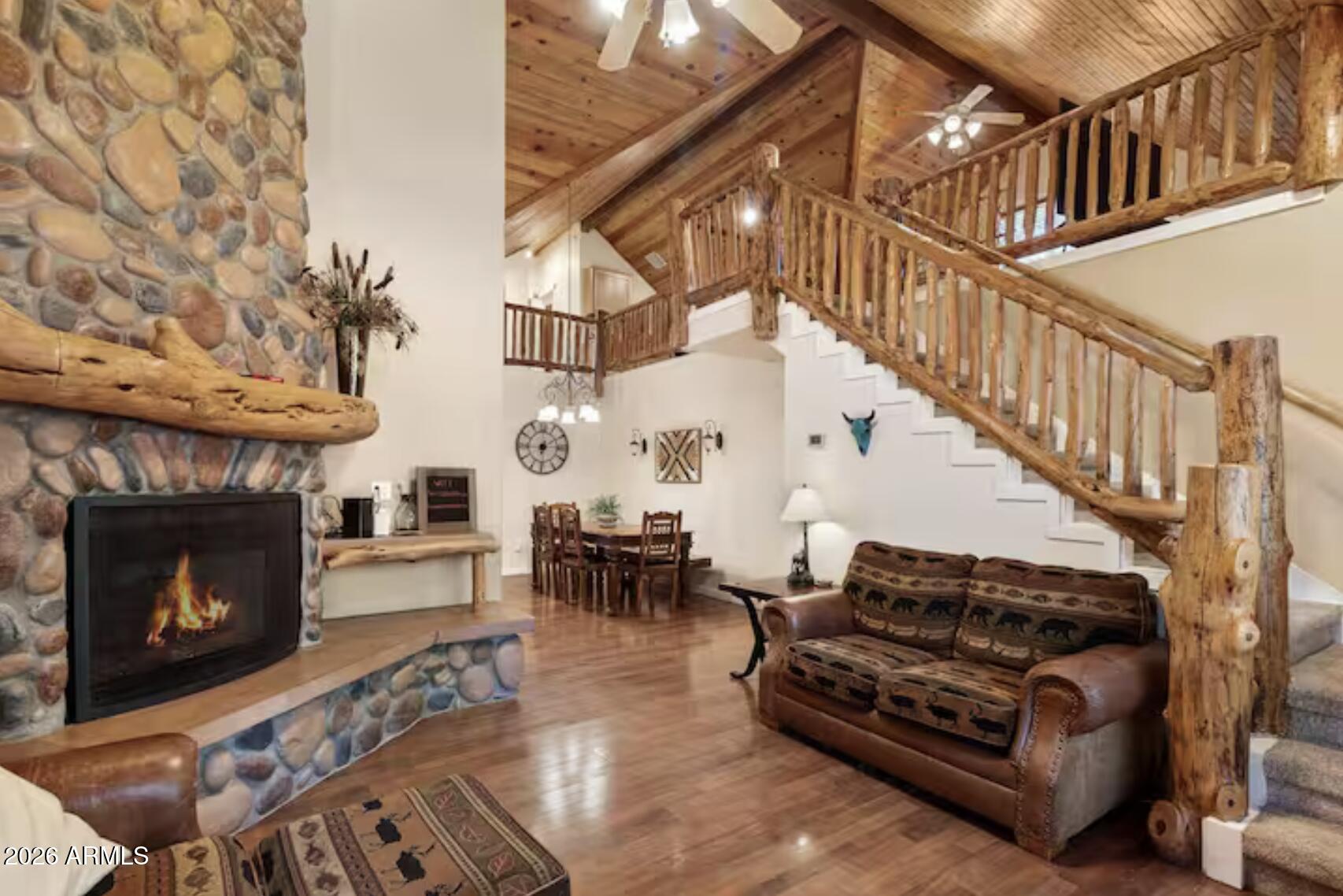 2540 Timber Ridge Lane Pinetop, AZ 85935 - Photo 7 of 37 a living room with couches a fireplace with wooden floor