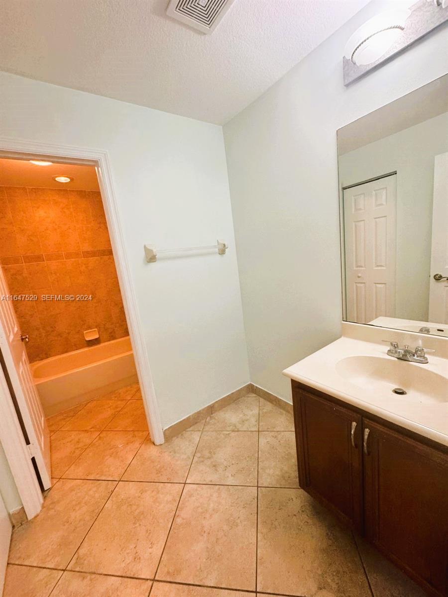 4527 Southwest 129th Avenue Miramar, FL 33027 - Photo 26 of 28 a bathroom with a sink a vanity and a mirror