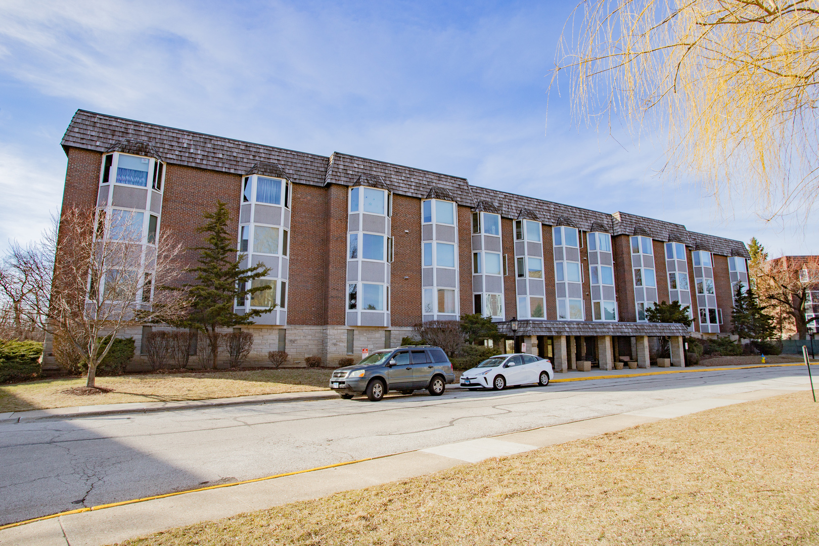300 Thames Parkway, Unit 1C Park Ridge, IL 60068 - Photo 1 of 19 a street view with tall buildings
