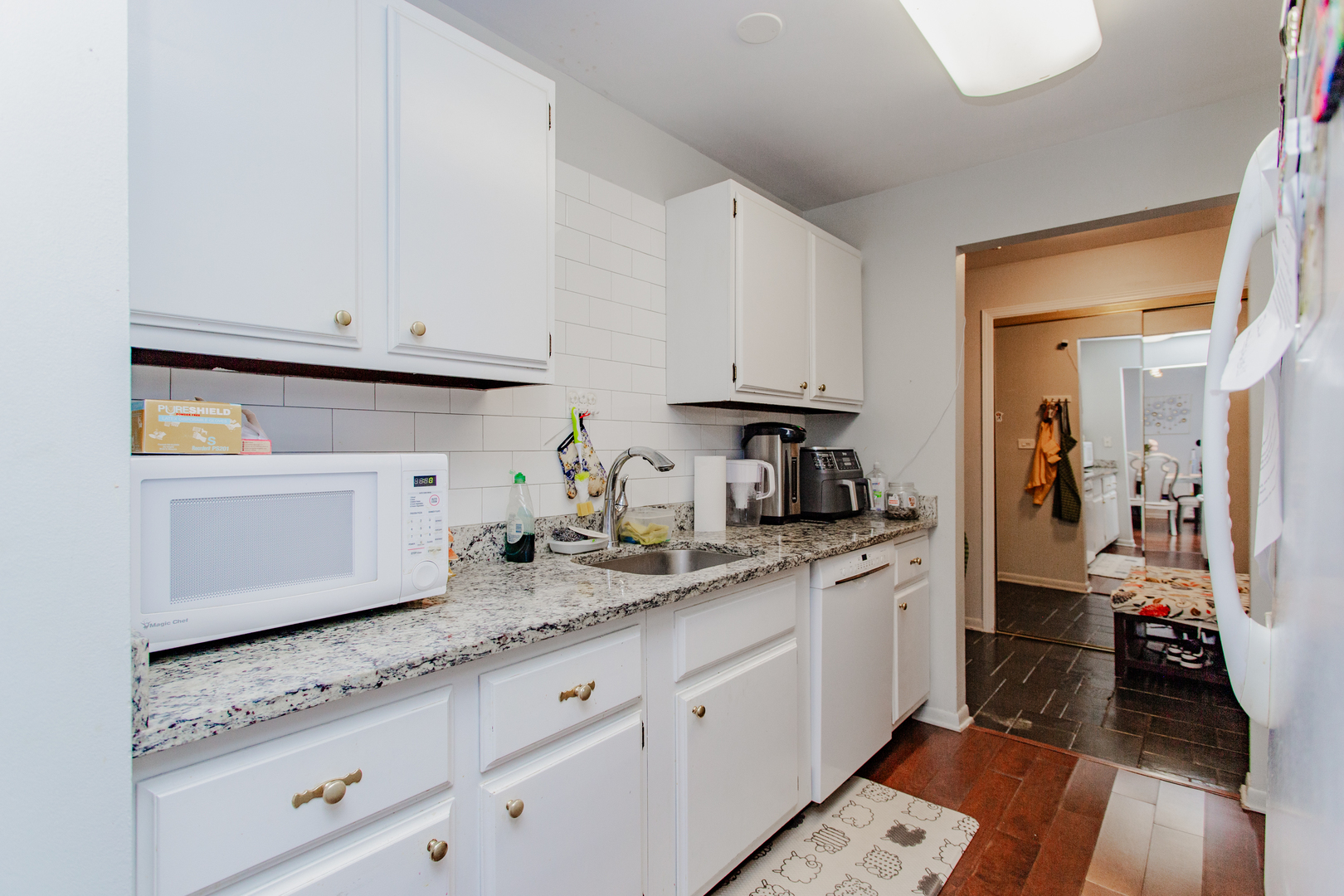 300 Thames Parkway, Unit 1C Park Ridge, IL 60068 - Photo 11 of 19 a kitchen with granite countertop white cabinets and a sink