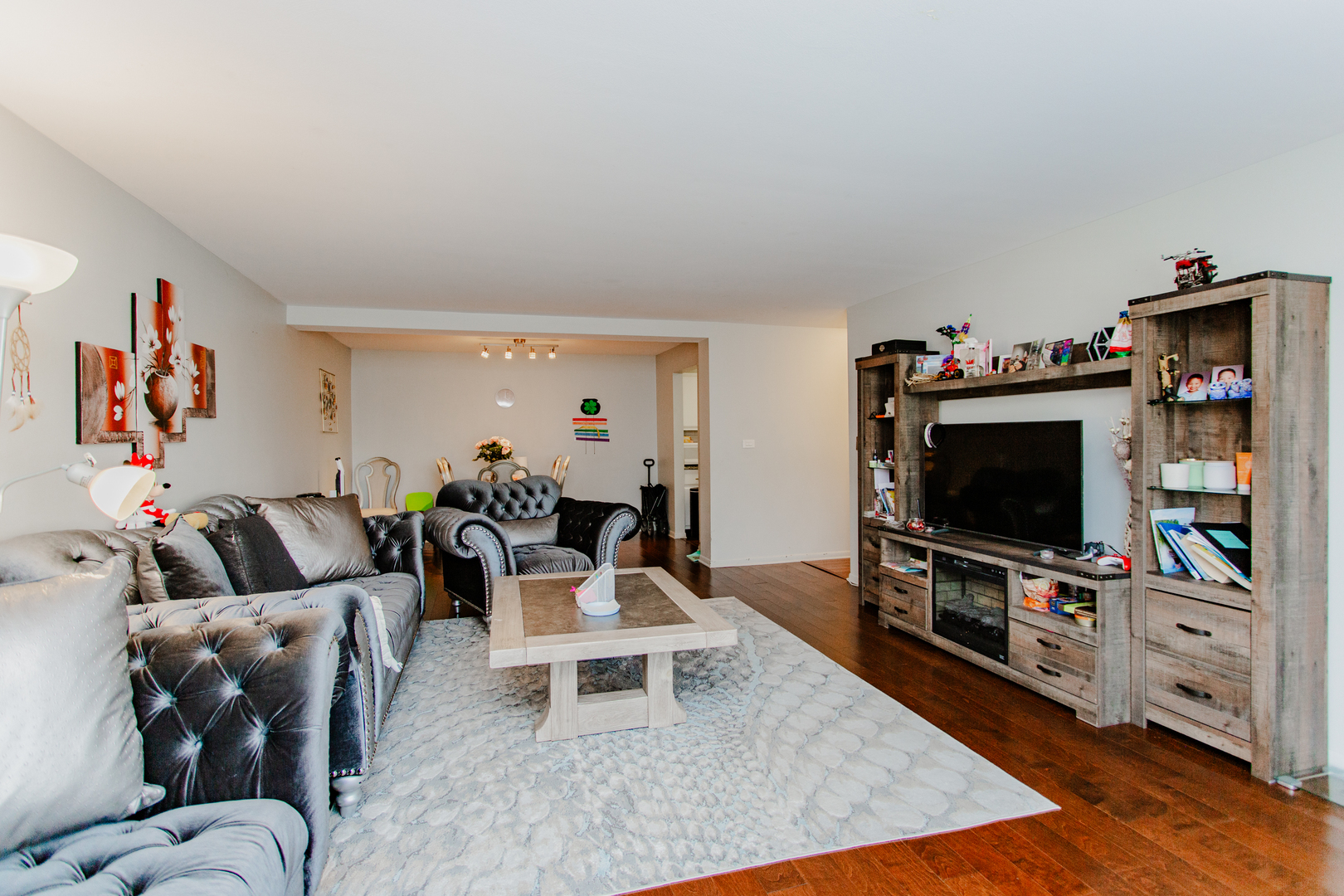 300 Thames Parkway, Unit 1C Park Ridge, IL 60068 - Photo 8 of 19 a living room with furniture and a flat screen tv