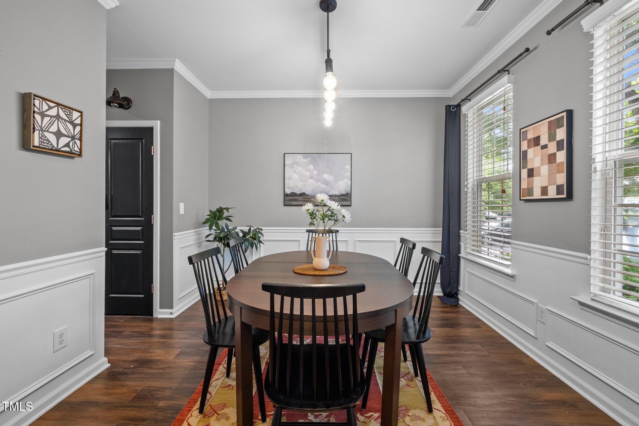 214 Cedar Elm Road Durham, NC 27713 - Photo 12 of 35 a dining room with furniture a window and wooden floor