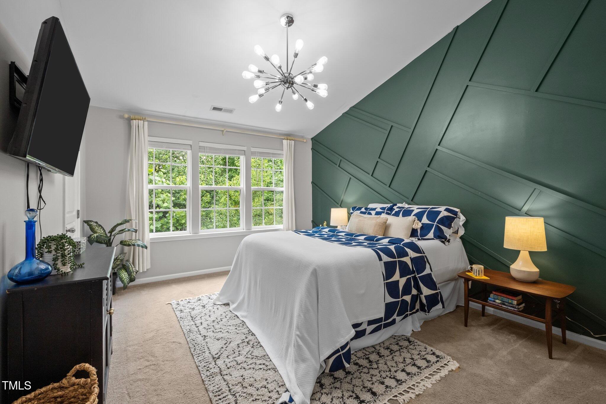 214 Cedar Elm Road Durham, NC 27713 - Photo 15 of 35 a bed sitting in a bedroom next to a window