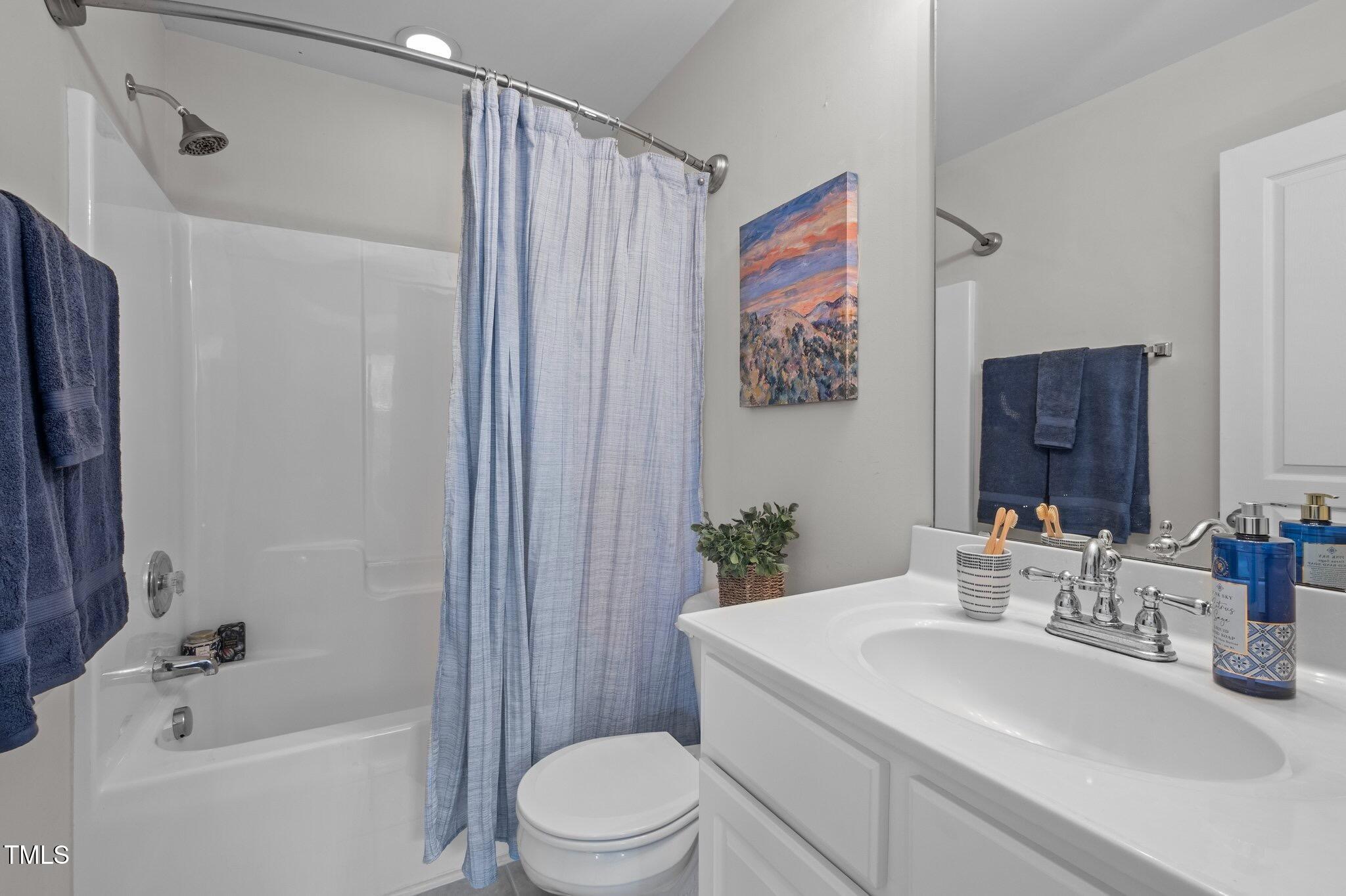 214 Cedar Elm Road Durham, NC 27713 - Photo 22 of 35 a bathroom with a sink a toilet and shower