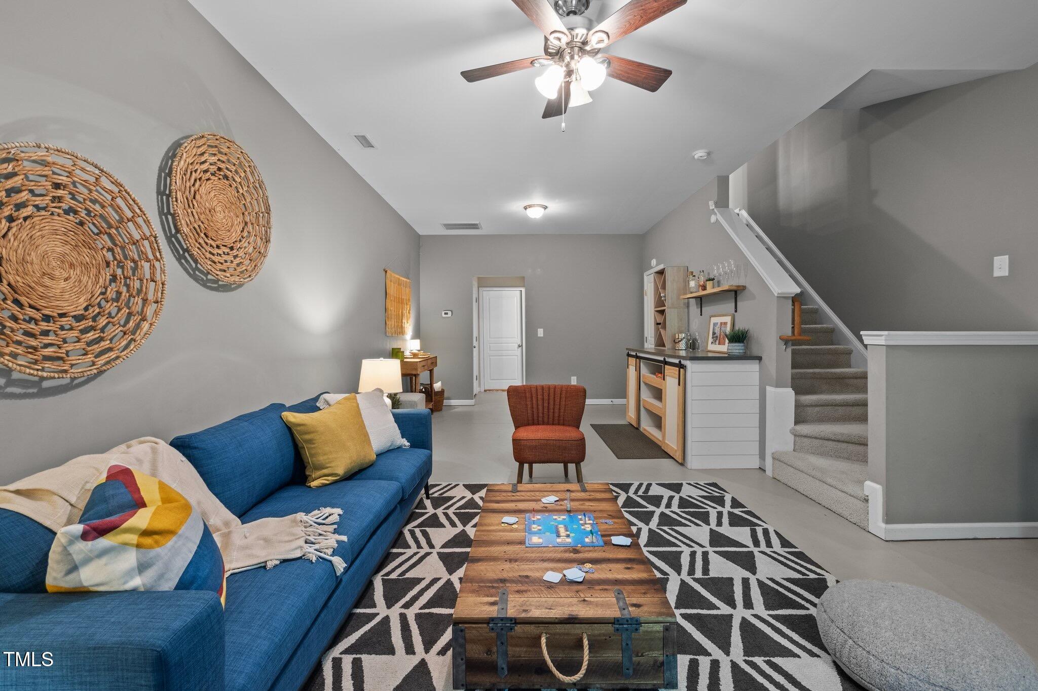 214 Cedar Elm Road Durham, NC 27713 - Photo 24 of 35 a living room with furniture and a chandelier