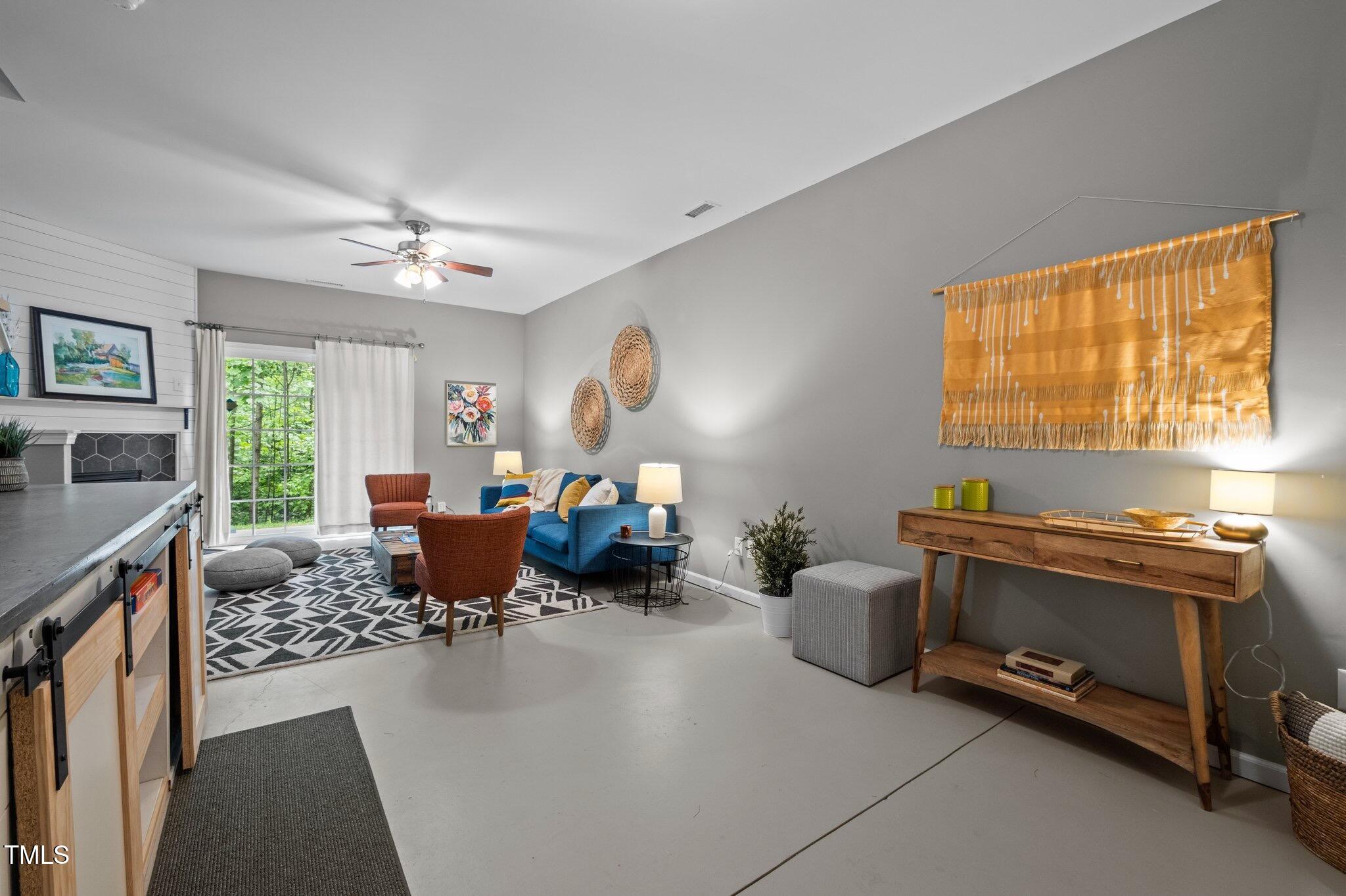 214 Cedar Elm Road Durham, NC 27713 - Photo 26 of 35 a living room with furniture a window and a fireplace