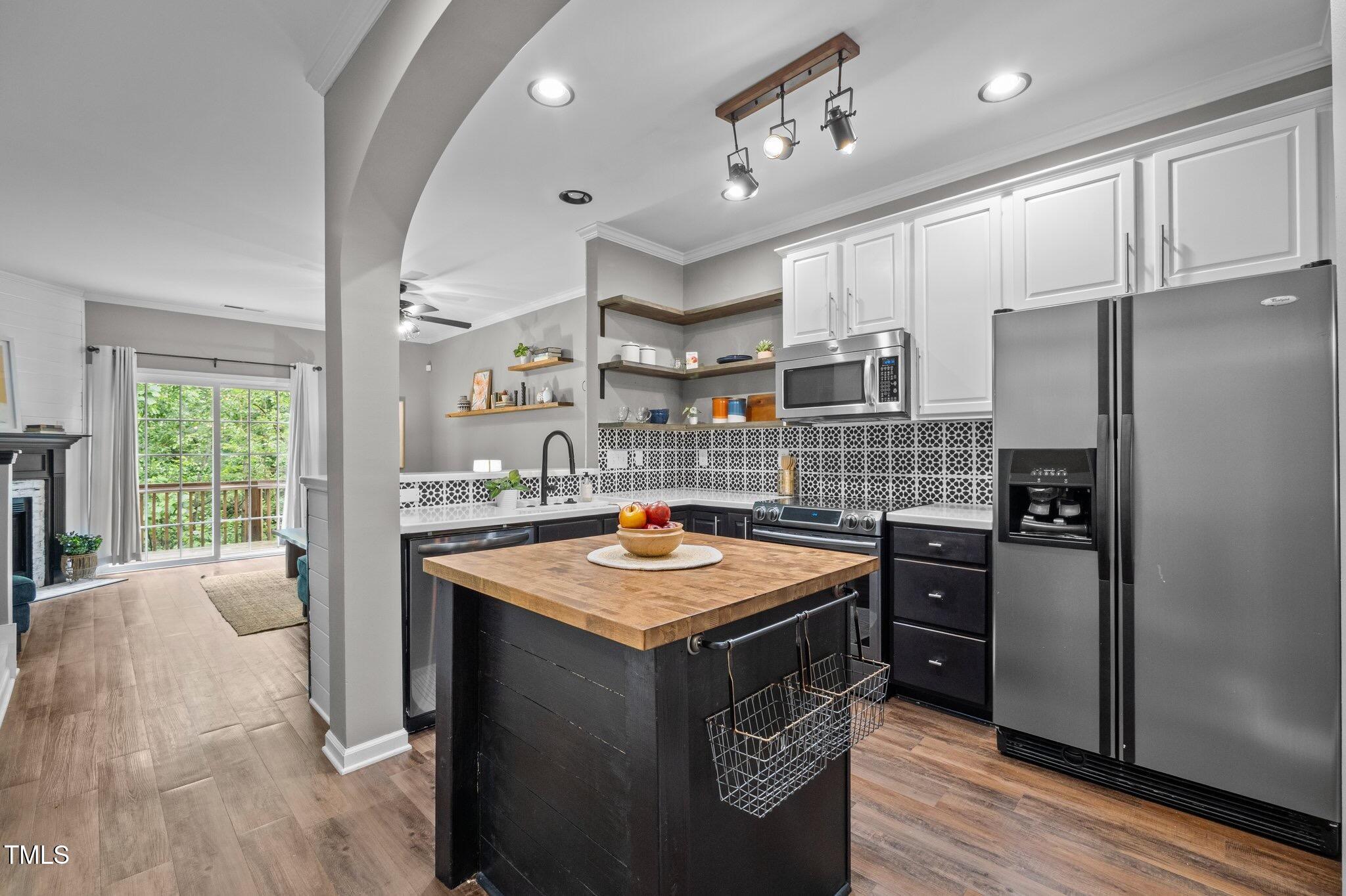 214 Cedar Elm Road Durham, NC 27713 - Photo 6 of 35 a kitchen with stainless steel appliances granite countertop a sink stove and refrigerator