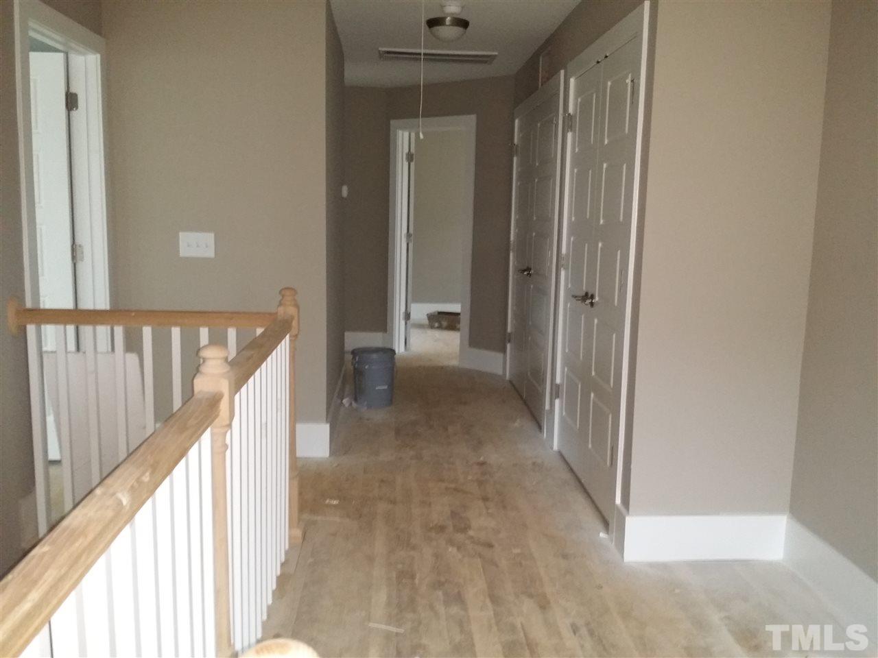 805 Edmund Street Raleigh, NC 27604 - Photo 6 of 13 a view of a hallway with wooden floor and staircase