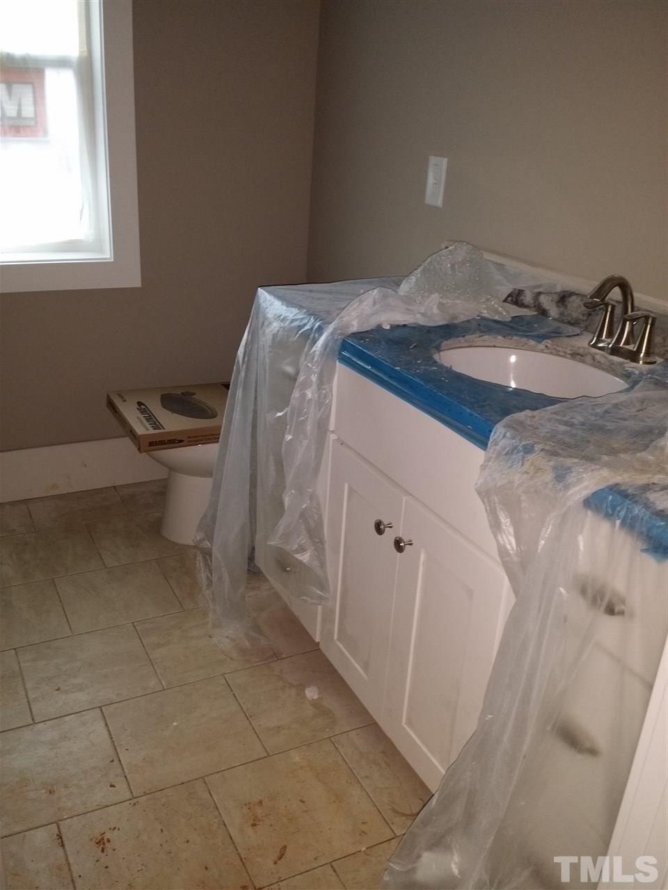 805 Edmund Street Raleigh, NC 27604 - Photo 9 of 13 a bathroom with a sink and a toilet