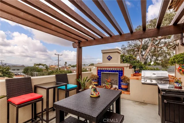 a roof deck with table and chairs