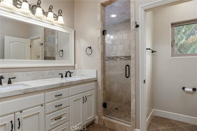 a bathroom with a shower sink and mirror