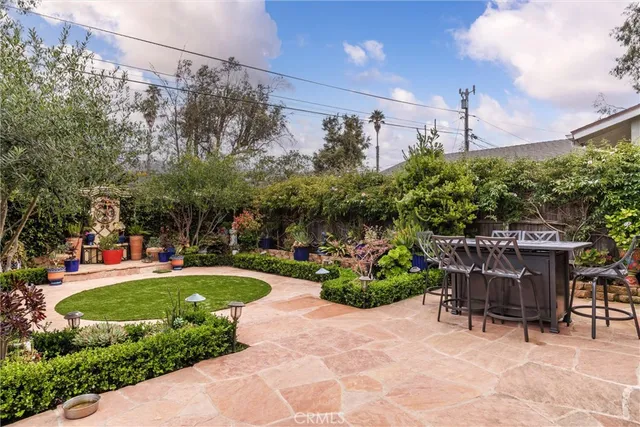 a view of a chair and table in backyard