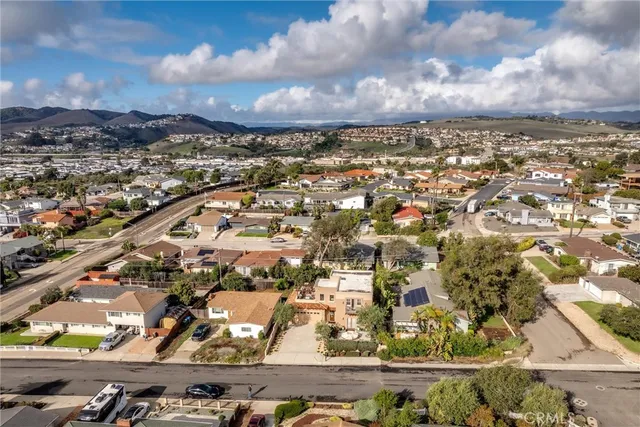 an aerial view of a house with a lake