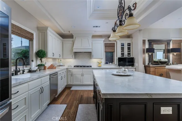 a kitchen with a sink stainless steel appliances and cabinets