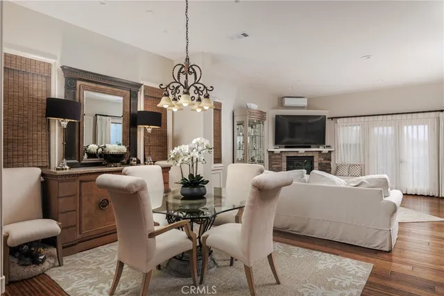 a living room with furniture a chandelier and a flat screen tv