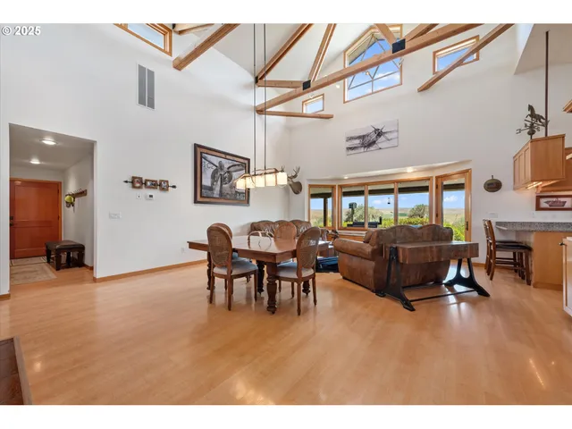 a living room with furniture and a dining table