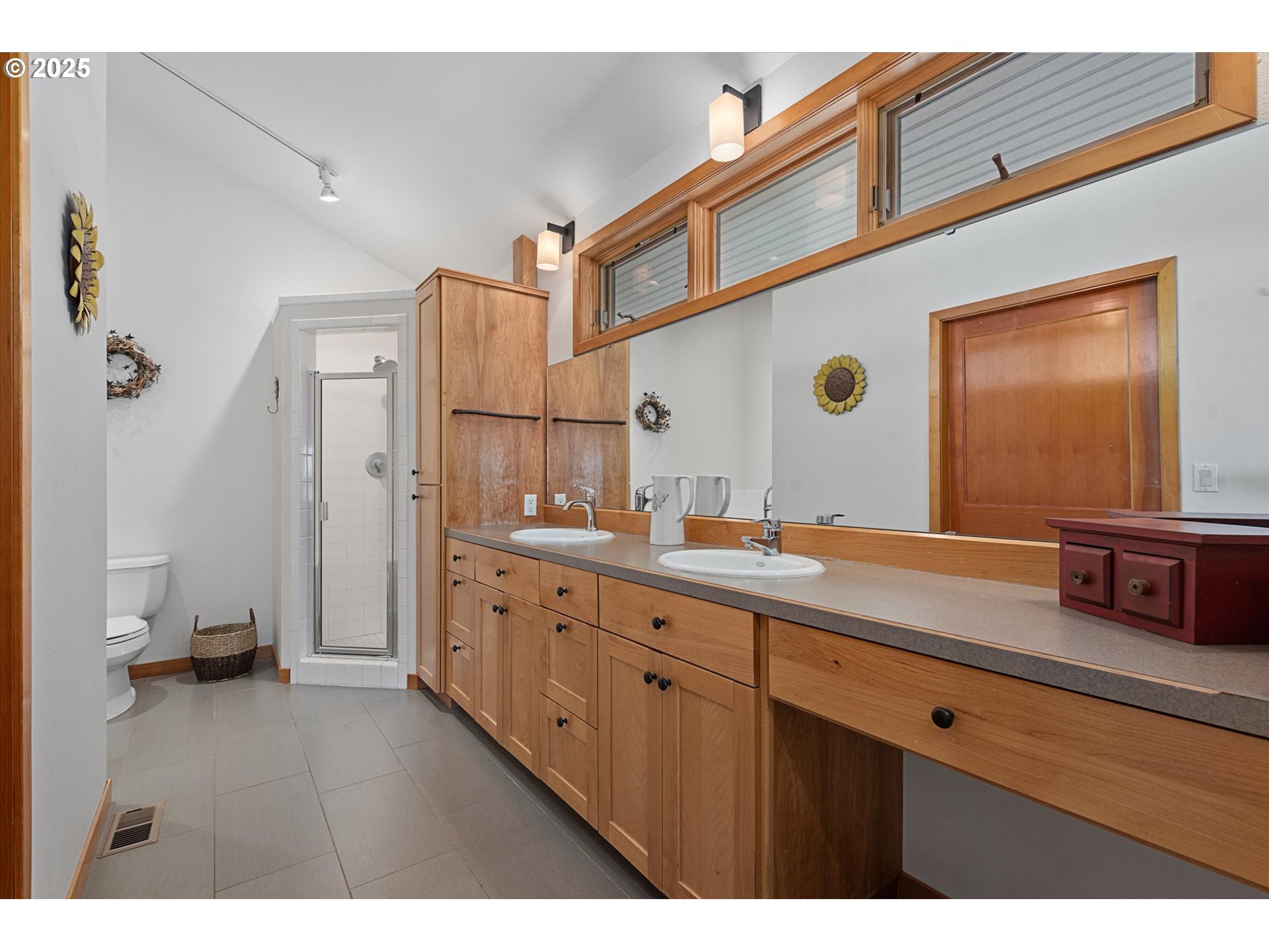 64209 Meadow Brook Road Lexington, OR 97839 - Photo 19 of 48 a bathroom with a double vanity sink and mirror