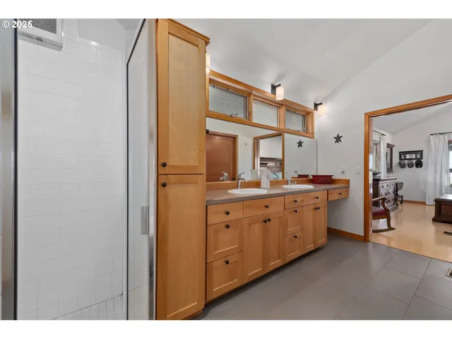 a bathroom with a double vanity sink mirror and