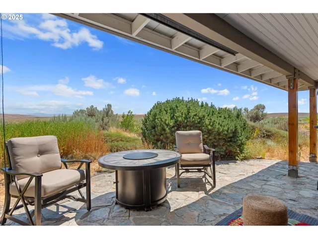 a view of a chairs and table in the patio