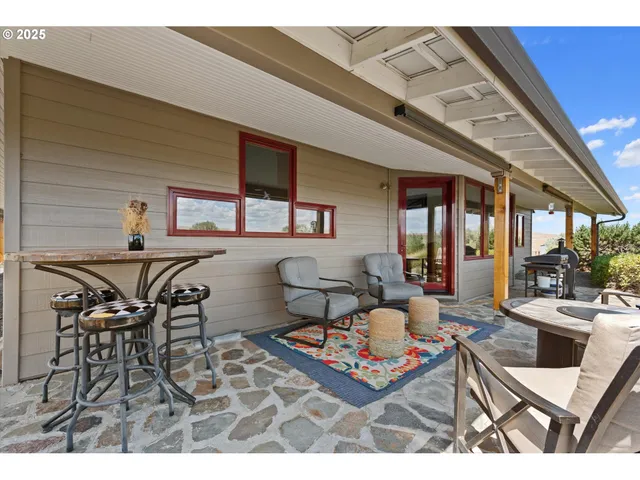 a living room with furniture a large window and table