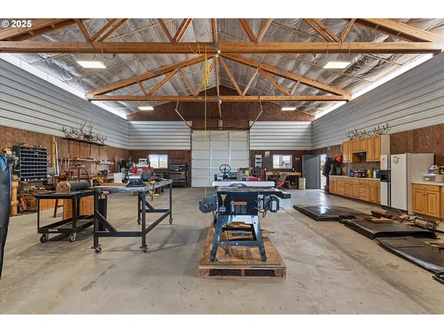 a living room with lots of furniture and kitchen