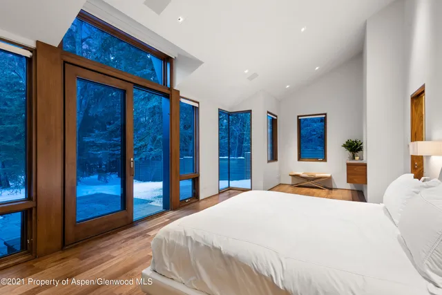 a bedroom with a large bed and a window