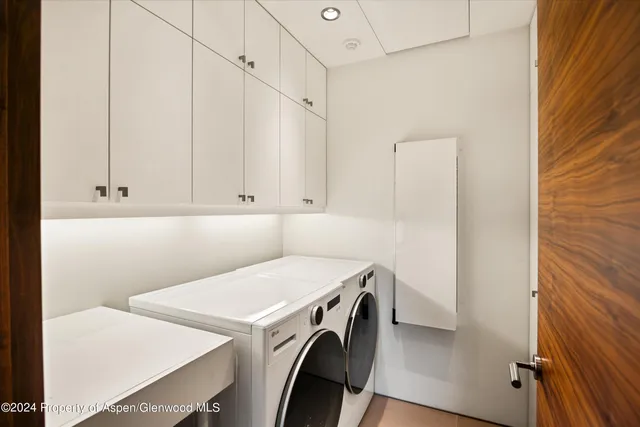 a backyard of a house with fountain table and chairs