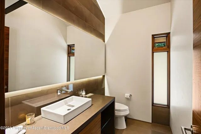a view of a patio with table and chairs with wooden floor and fence