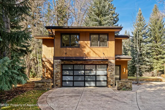 a view of a patio with table and chairs with wooden floor and fence