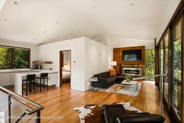 a view of a patio with a dining table and chairs with wooden floor and fence