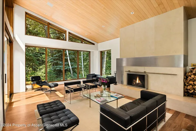 a living room with a large window and a table