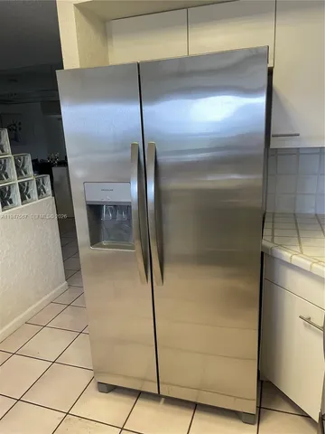 a kitchen with a refrigerator and a stove