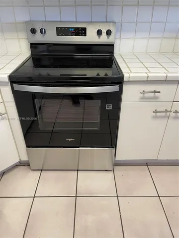 a stove top oven sitting inside of a kitchen