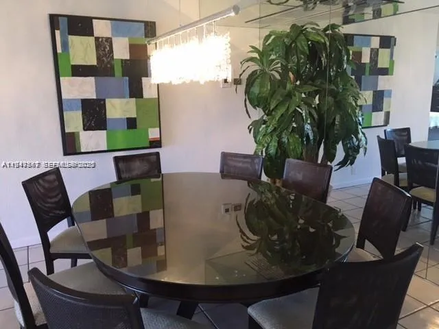 a dining room with furniture potted plants and wooden floor