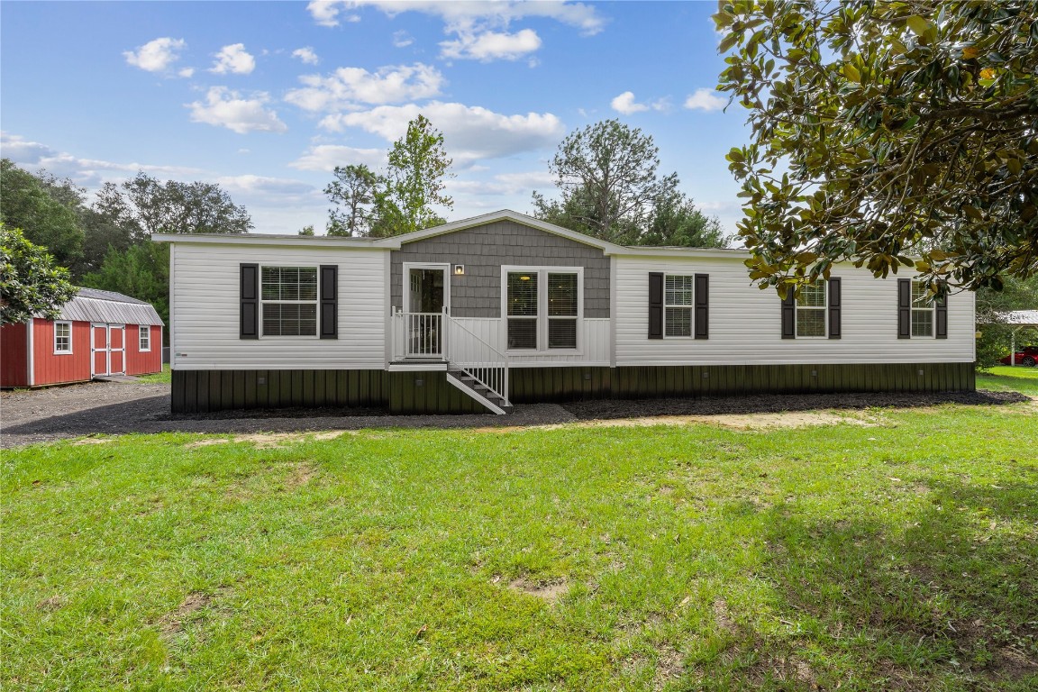 85128 Angie Road Yulee, FL 32097 - Photo 1 of 14 a front view of a house with a yard