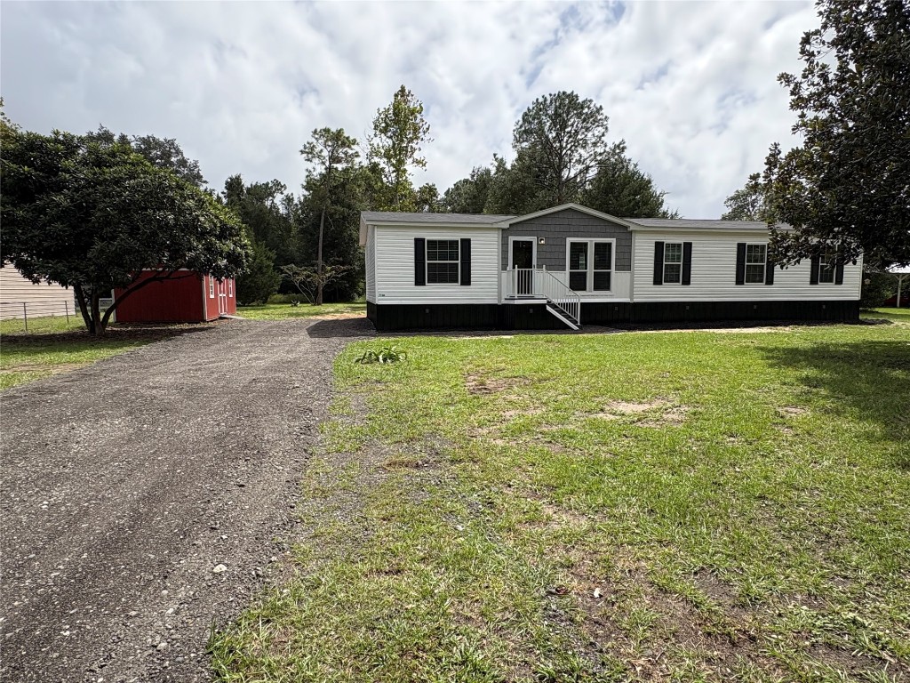 85128 Angie Road Yulee, FL 32097 - Photo 2 of 14 a front view of a house with a garden