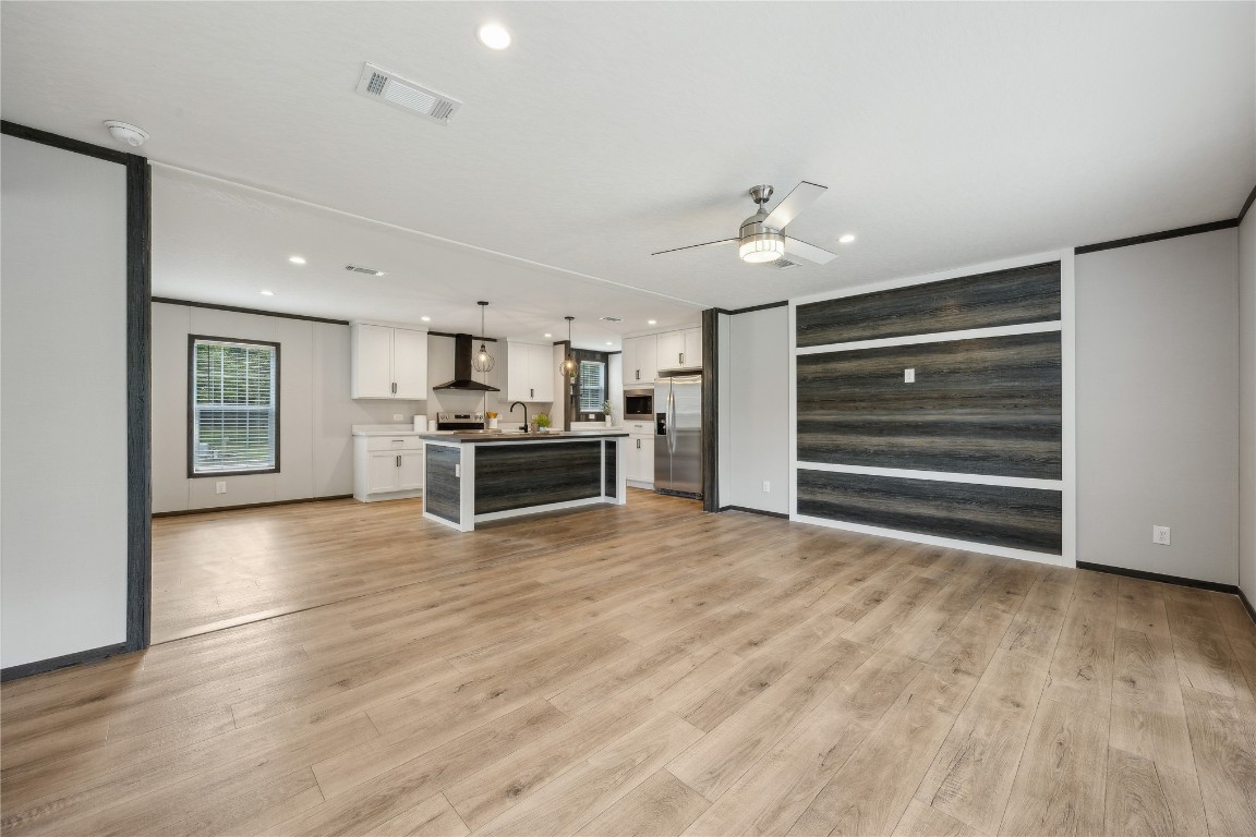 85128 Angie Road Yulee, FL 32097 - Photo 4 of 14 a view of a kitchen with a stove cabinets and wooden floor